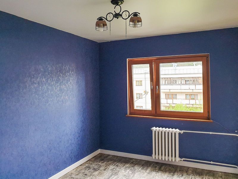 Bedroom with a dark blue accent wall